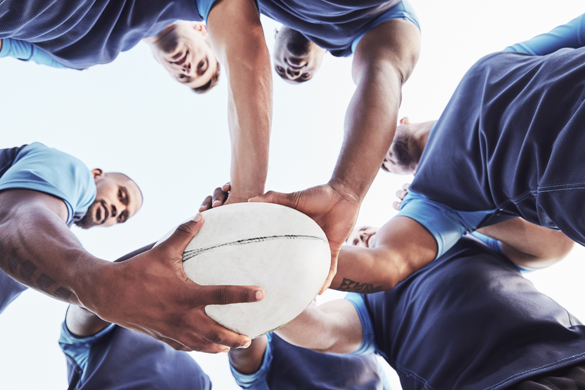 a football team holds a football